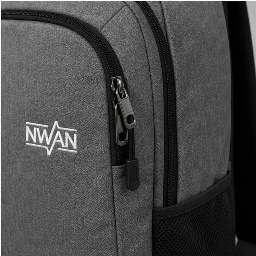 Close up of backpack zipper pull shoulder strap stitching and NWAN logo detail